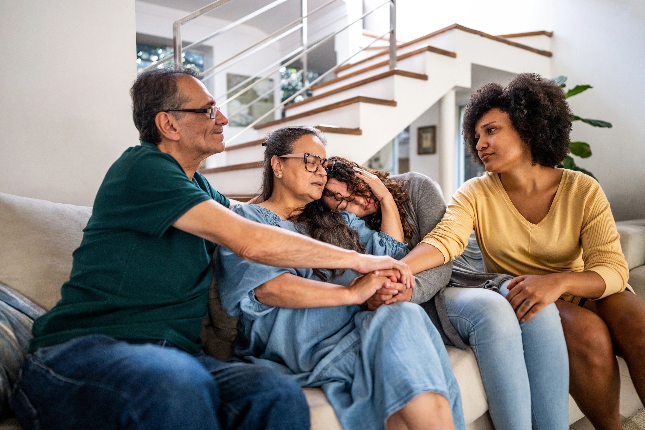 Family members offering comfort and support in a living room