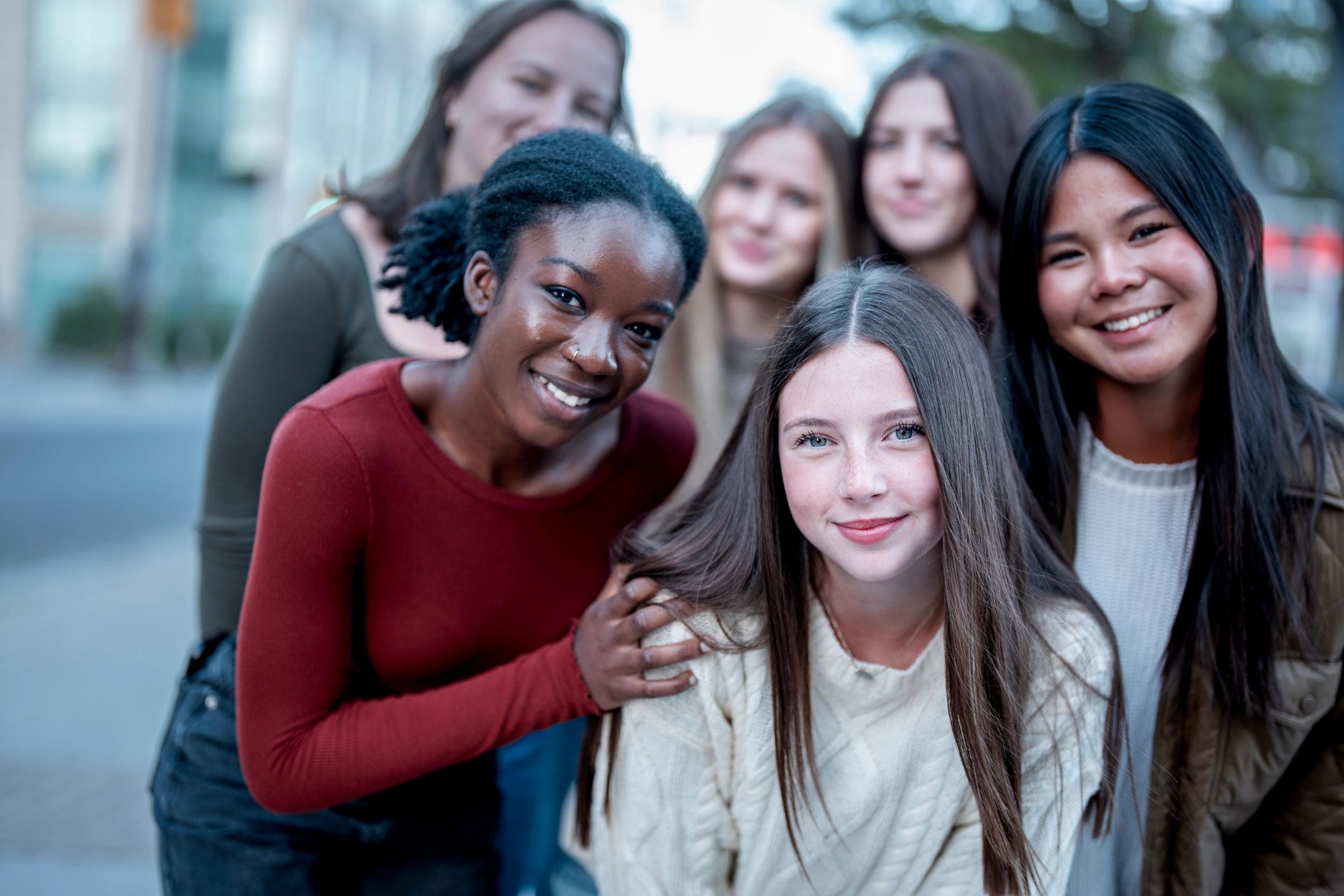 Teen girls smiling together outdoors