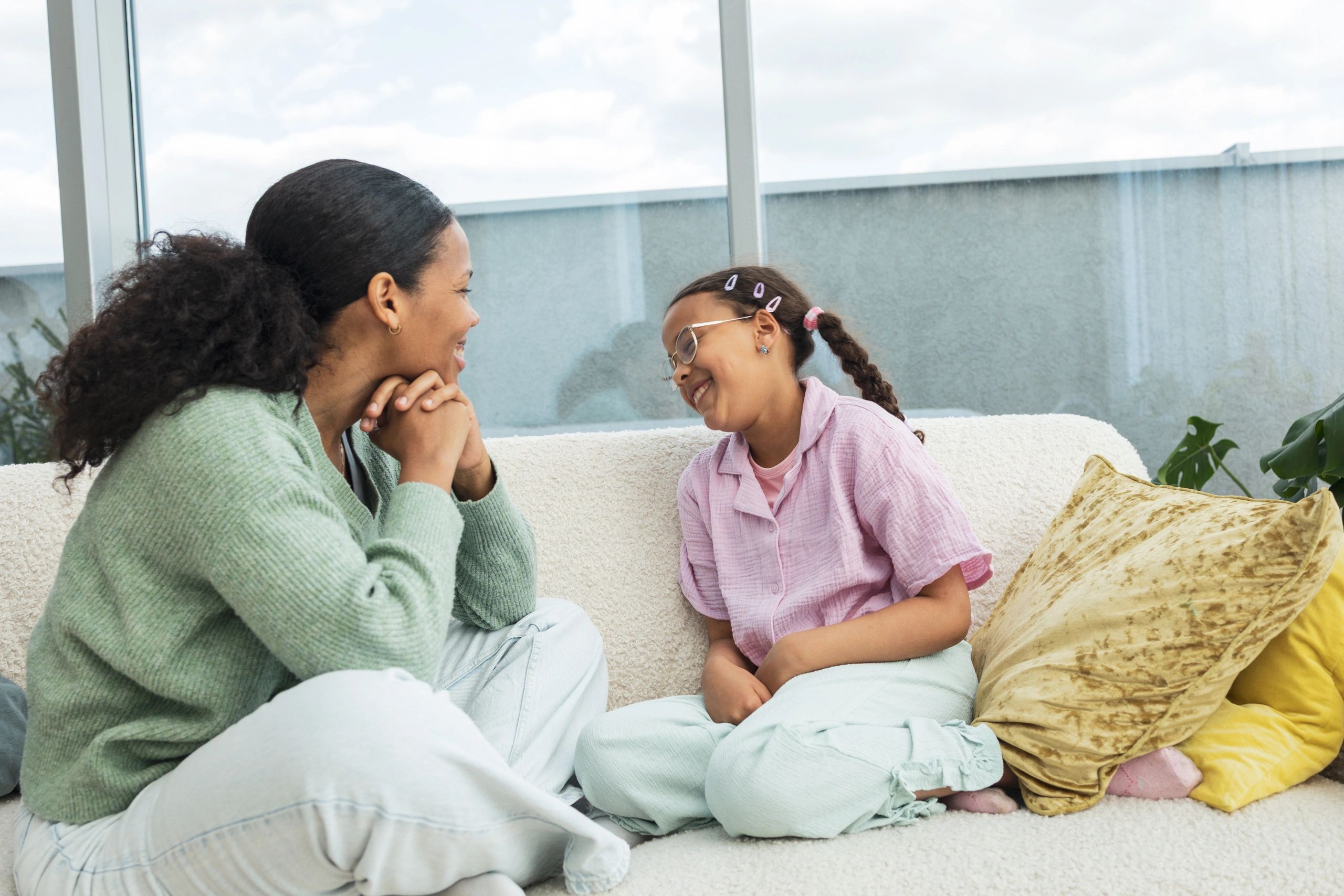Parent and child talking together on a sofa